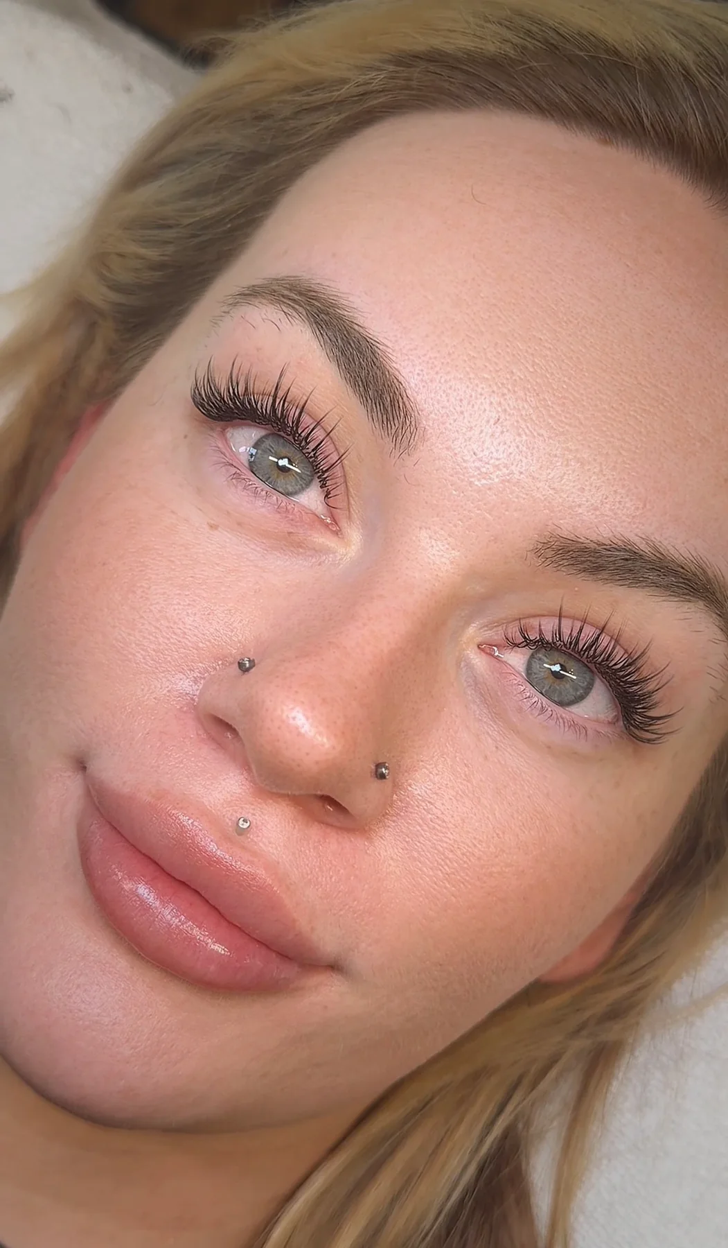 Natural wispy lash extensions on a client