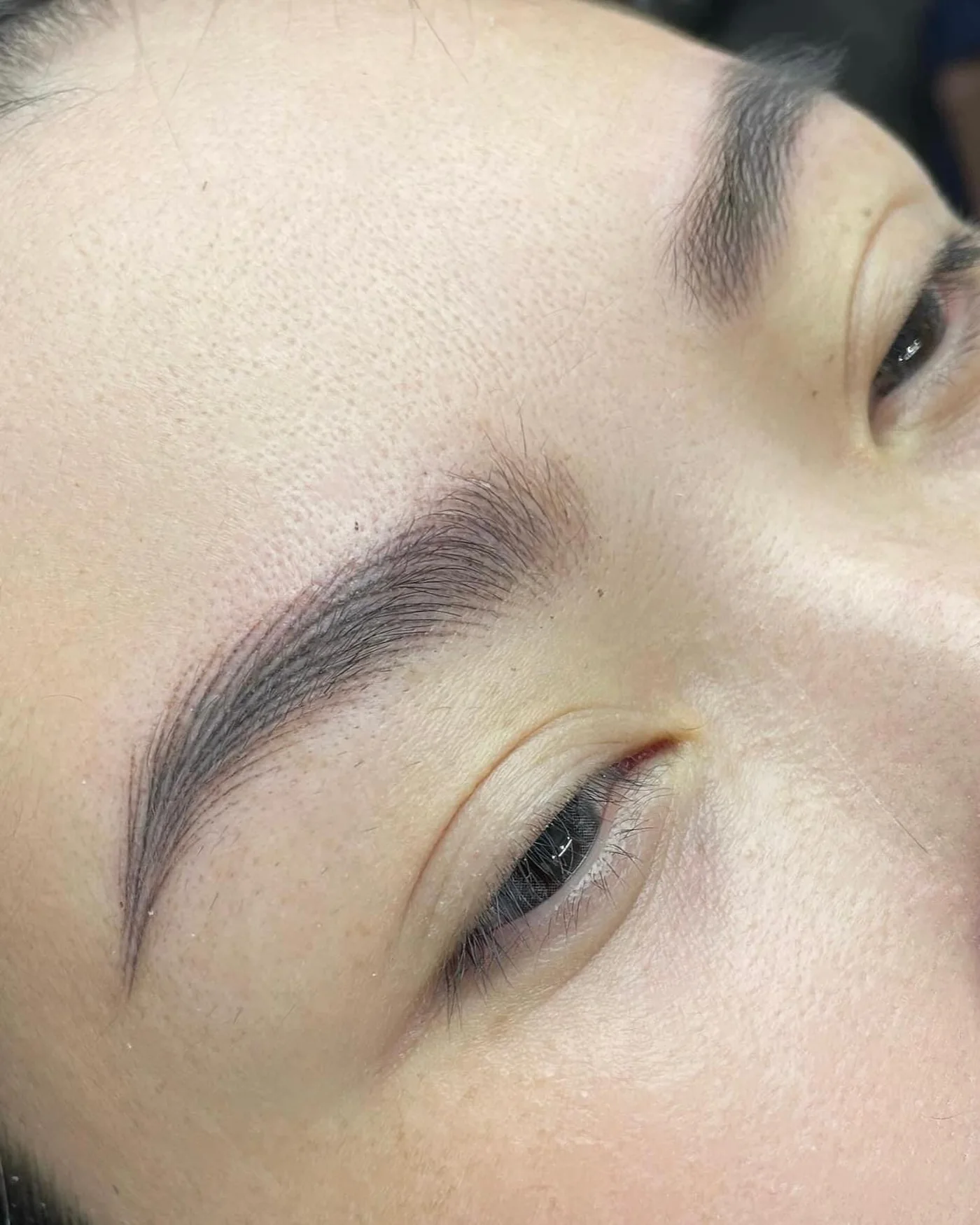Natural permanent makeup brows from a side angle